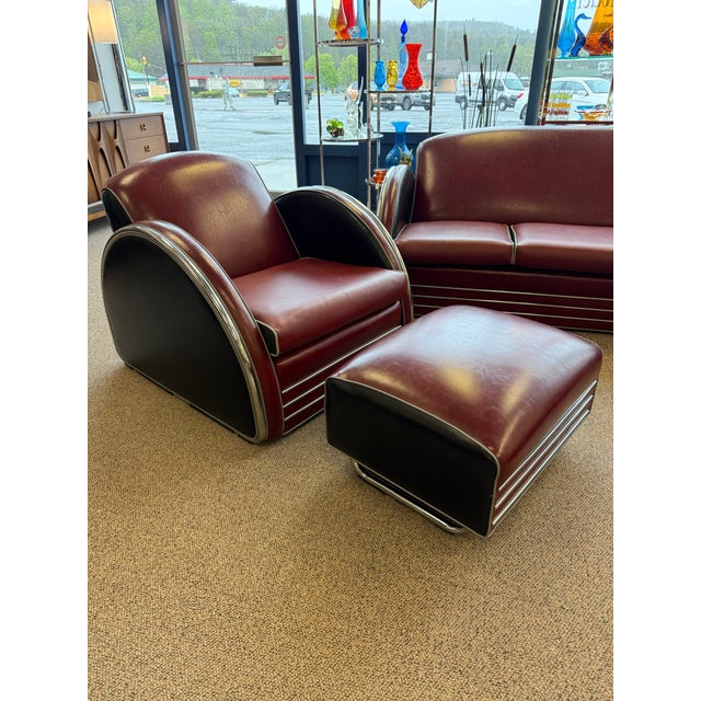 This burgundy, black and gray seating set is a limited re-creation of a Streamline Moderne collection designed by the...