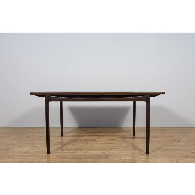 This magnificent mid-century dining table was designed by Ib Kofod-Larsen and manufactured by G-Plan circa 1960. It is...