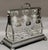 For your consideration. . . An antique English silver plated Tantalus, circa 1900. The set comes with three matching cut...