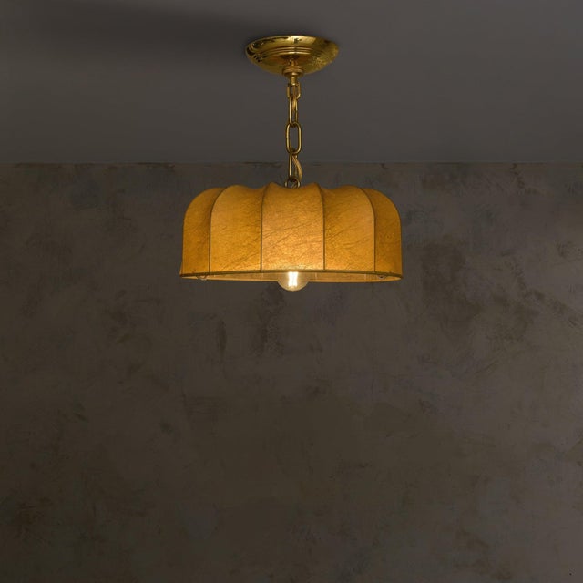An Italian pendant light from the 1960s, featuring a sculptural half-dome shade formed using the cocoon technique....