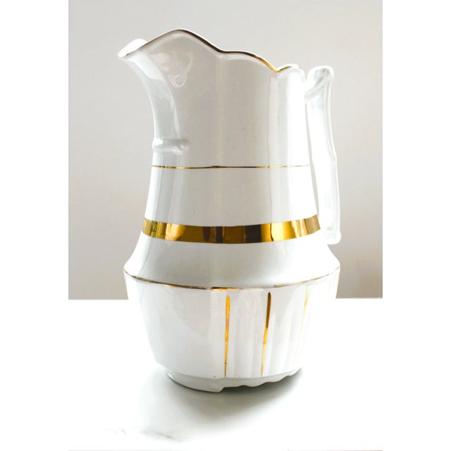 Exceptional 1883-1913 C. Large English white ironstone pitcher. We love it's unique gilded gold banding and decorations'...