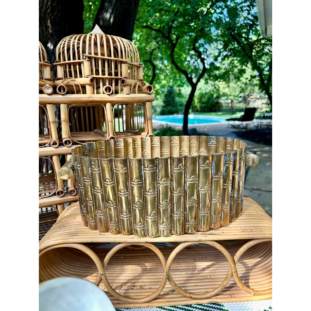 Chic vintage brass planter featuring an oval form with an allover faux bamboo design and decorative handles at each end....