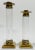 Stately vintage pair of Hollywood Regency style brass and lucite candlestick holders. Taller measures 10.75"H and the...