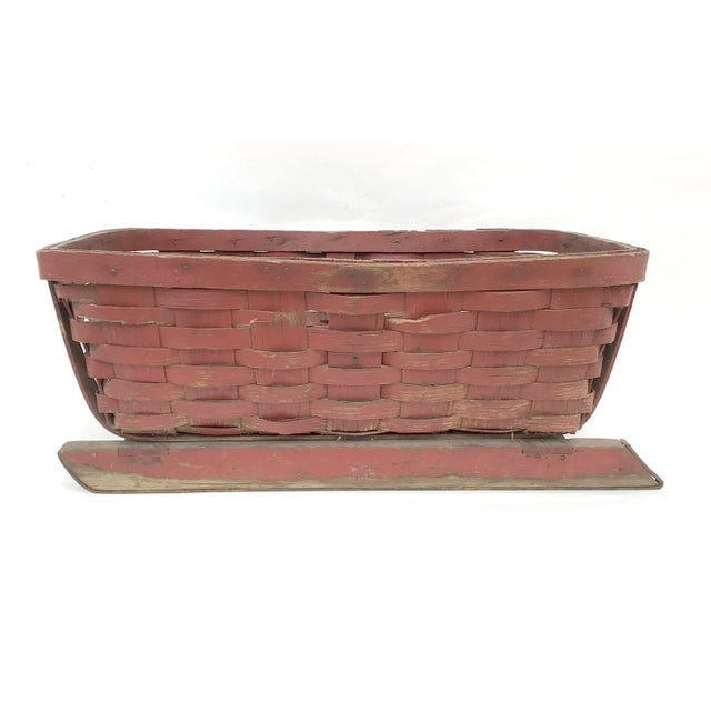 Found in Maine circa 1930s/40s original red painted splint basket with sled runners, basket has eye hook where rope was...