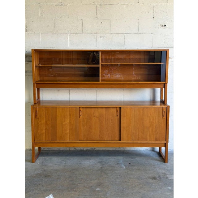 Beautiful Mid Century Modern Danish teak hutch / credenza, crafted in the 1960s with clean lines and refined Scandinavian...