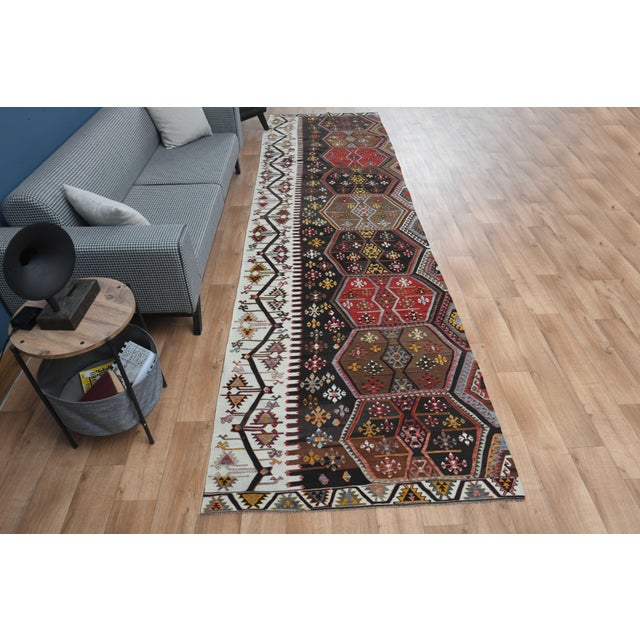 Vintage Hand-Knotted runner rug is a semi-antique vintage area rug. The '70s Eastern region of Anatolia's unique rug is...