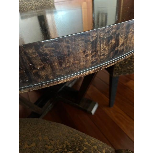 An Elegant Lucien Rollin Collection dining set, featuring a 55" x 30" round table with extension leaves that transform it...