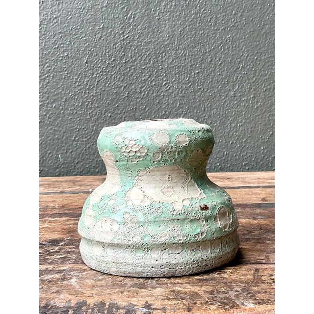 This vintage textured ceramic vase is a compelling example of mid-century studio pottery, celebrated for its organic form...