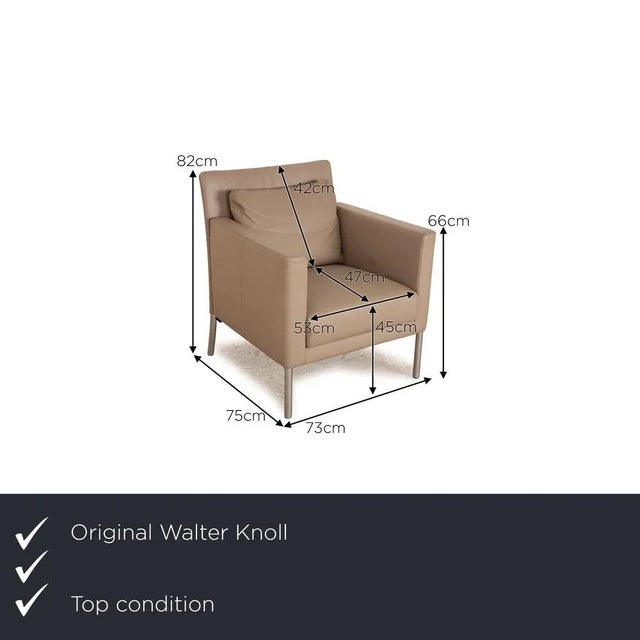 The Jason armchair by Walter Knoll is covered in gray genuine leather and stands on metal feet. The simple design and the...