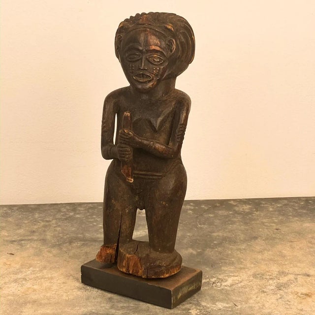 A 20th Century carved wood ancestry figure, Africa on a later custom steel stand.