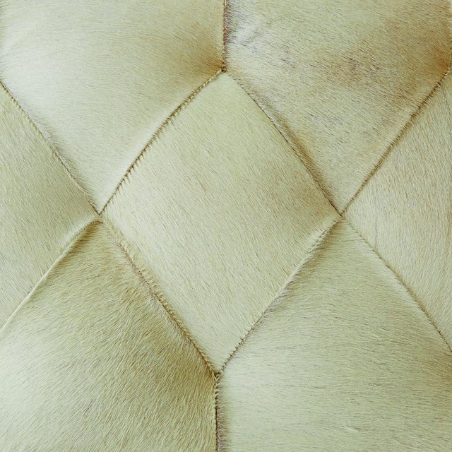 The Stiletto Bench combines bold design with comfort, featuring a tufted white hair-on-hide cushion supported by sleek...