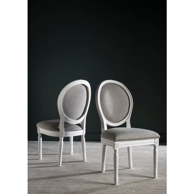 Brim With French country charm, this set of two dining chairs boasts a classic cream frame, light grey linen upholstery...