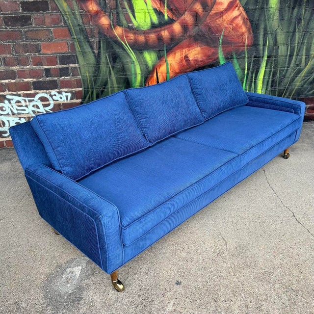 Sofa has all new foam and upholstery in an amazing blue corduroy. Believe it to be a design from Selig but can not confirm.