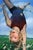 Olympic Lyla by Denise Dambrackas | Mixed-media: Acrylic & Oil on Panel of a girl doing a handstand in a field. For Sale
