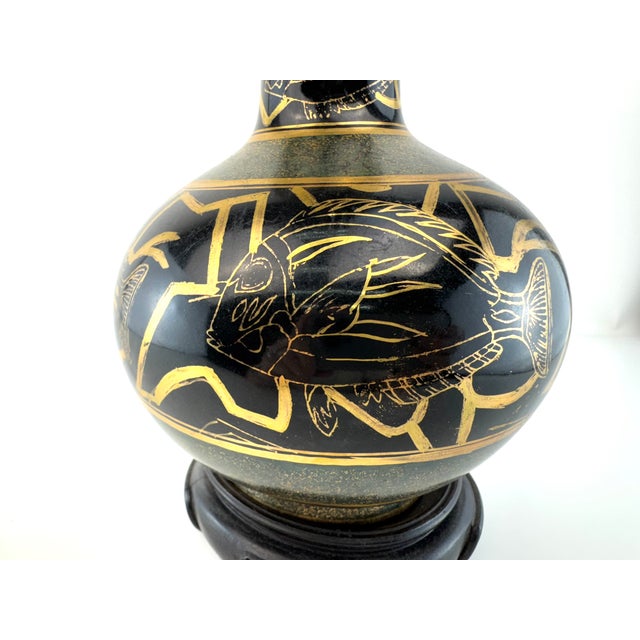 A striking vintage ceramic vase finished in deep black with hand-applied gold decoration in a classical Greek revival...