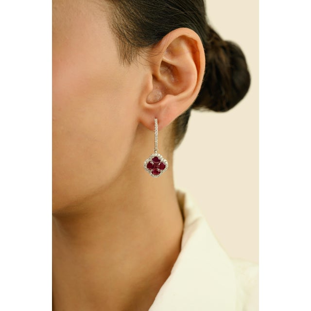 These elegant drop hoop earrings feature 10 oval & square cut rubies totaling 3.94 carats, set in rich 14k white gold....