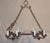 A robust eight-light iron chandelier. This single rod chandelier has a long thin twisting piece running along the bottom,...