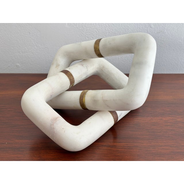 Heavy white marble sculpture links with brass rings. Use as shape for interest or paperweight for desktop. Most items...