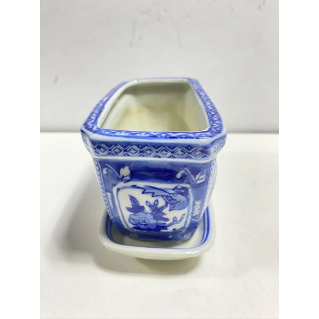 A charming vintage blue and white porcelain rectangular cachepot with coordinating undertray. The hand-painted landscape...