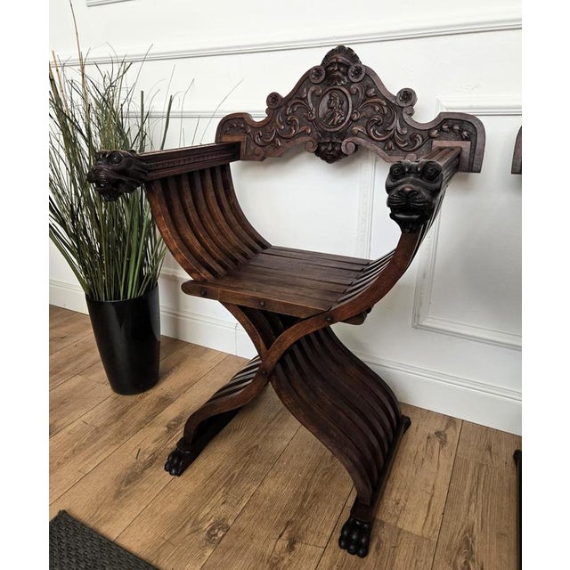 Beautiful Savonarola chair in amazingly carved walnut. The backrail, the armrests start and ending, the front and back...