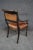 Regency leather chair with cane bottom and drag head accents on arms