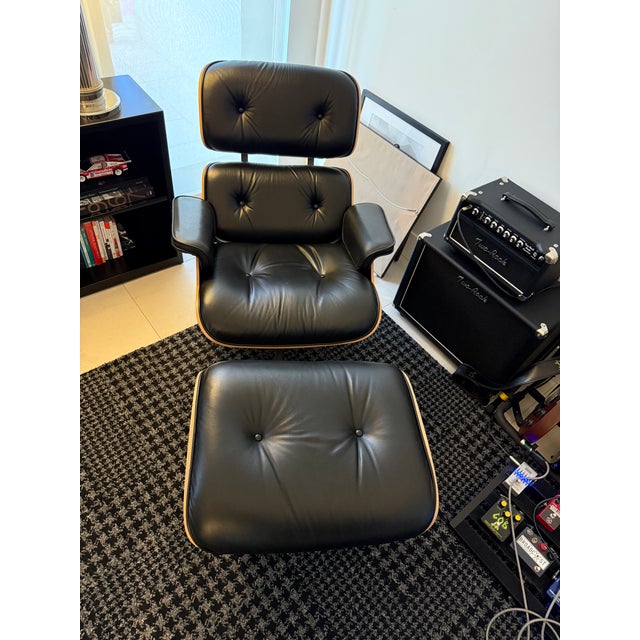 Materials: Shell: Santos Palisander Upholstry: Black leather Tall Chair Height (in): 33¼ Width (in): 33½ Depth (in): 37¾...