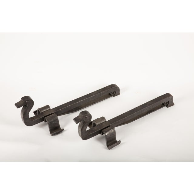 A charming and meticulously crafted pair of French duck-shaped andirons, showcasing exceptional metalworking skill. Likely...