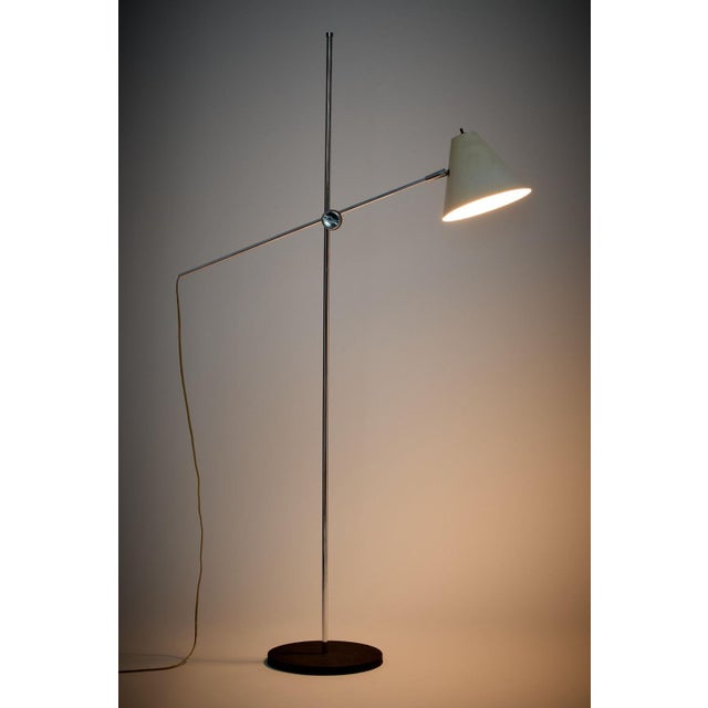 A 1970's adjustable floor lamp by George Kovacs. The lamp features a tubular chromed steel stem, cantilevered arm that...