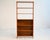 Teak bookcase with open shelves and a wooden back panel in the lower section. Scandinavian production from the...