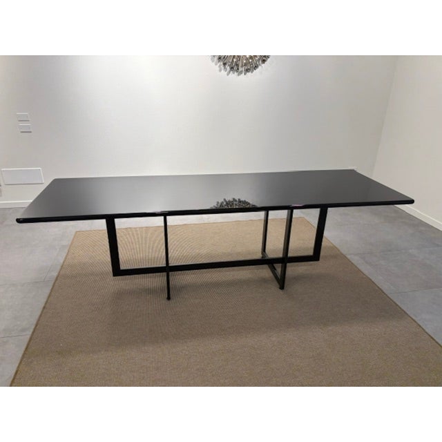 Glossy black lacquered wooden table with matt black lacquered metal base. 250x80 cm, height 75 cm. Italy, 1970, excellent...