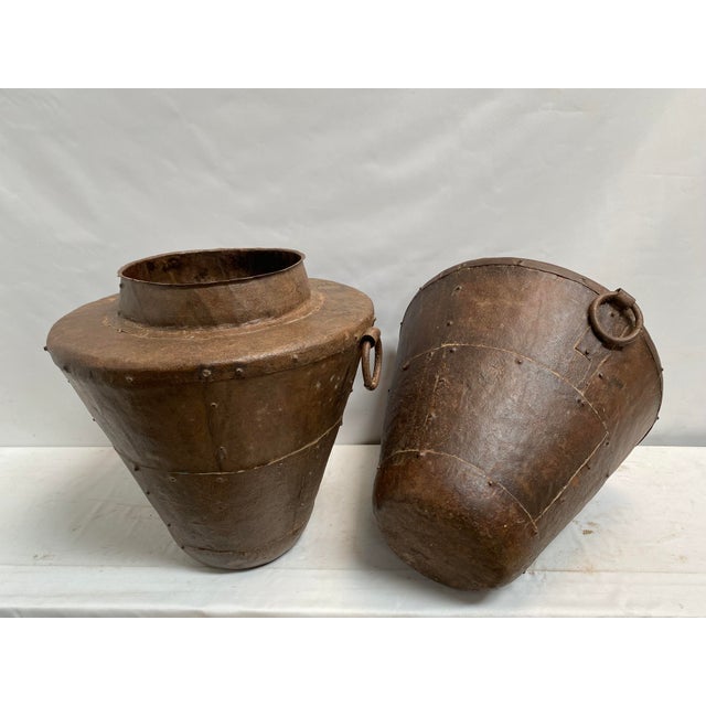 Tapered Storage Vessel Pair. Our metal garden urns are graceful and functional additions to outdoor spaces. These urns are...