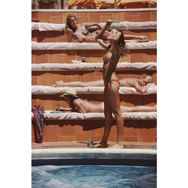 Catherine Wilke 1980 1980. Catherine Wilke joins the topless sunbathers on the island of Capri. Photo by Slim Aarons paper...