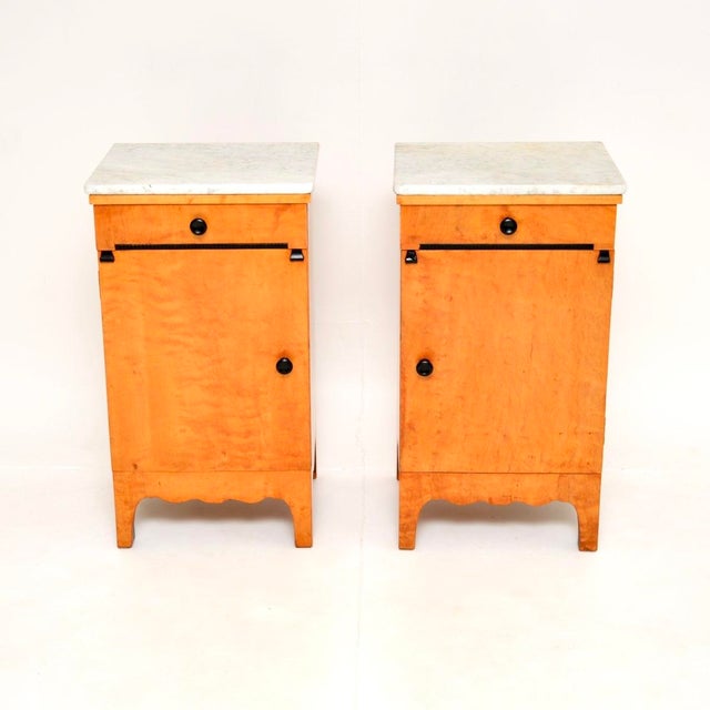 A beautiful pair of antique Swedish satin birch marble top bedside cabinets. They were recently imported from Sweden, they...