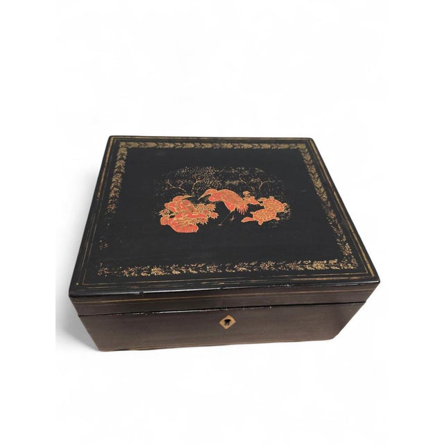 An elegant 19th-century Chinese lacquered box, richly decorated and full of character. Its exterior is finely lacquered,...