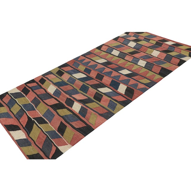 This vintage 5x12 Persian Kilim is believed to be a tribal rug of Karadagh—a mountainous region known for its craft....