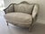 A beautiful vintage Louis XV style bergère settee featuring an intricately carved wood frame with a softly distressed...