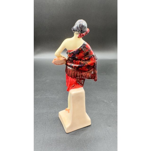 Beautiful rare vintage Royal Doulton Art Deco figurine featuring a striking red and black color scheme, wearing a vibrant...