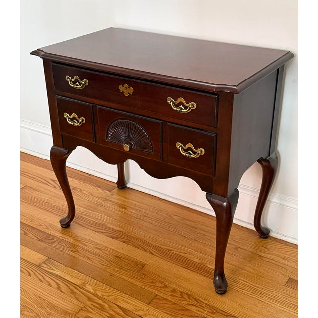 Late 20th century Thomasville Queen Anne style lowboy. American made. Features cherry wood with brass hardware and...