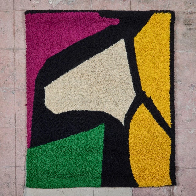 Color block hand knotted carpet weave tapestry, c.1972, USA. A brightly colored wall hanging with black outlined shapes....