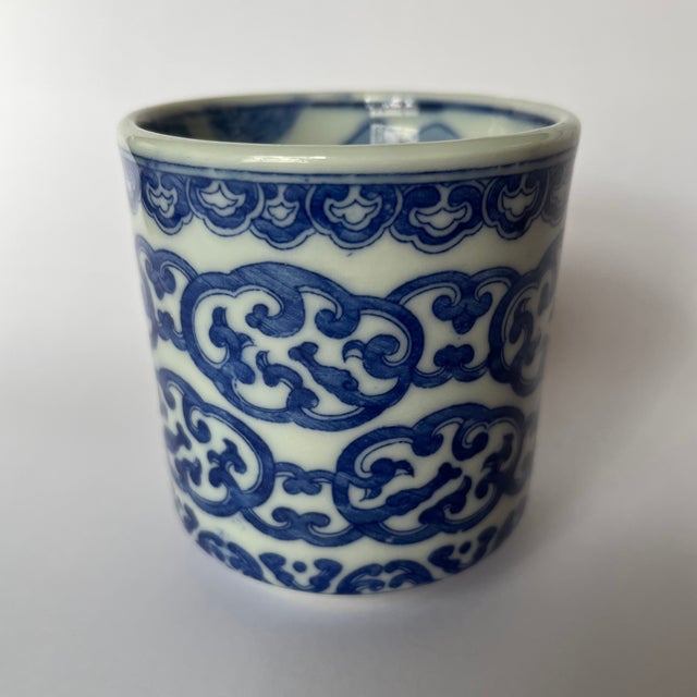 A single small round Chinese export porcelain cup or vessel featuring transfer decoration of stylized clouds on the...