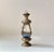A small scaled lantern executed in patinated brass and featuring panels of colored and etched glass. It has a tea light as...