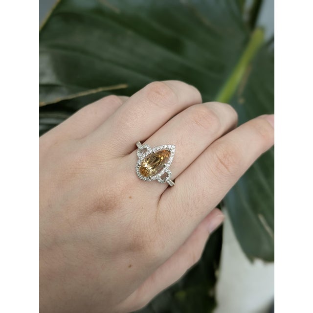 This graceful ring features a 2.53ct pear-shaped Imperial Topaz from Brazil, measuring 12.3x6mm and heat-treated to...