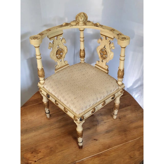 This Antique Italian Renaissance arm corner chair features intricate carvings and a painted finish, adding a touch of...