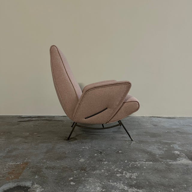 Vintage 1950s armchair, designed by Nino Zoncada. The armchair features a wraparound shape with a slightly inclined...