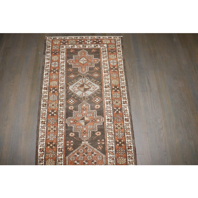 an early 20th Century Brown Geometric Persian Heriz runner