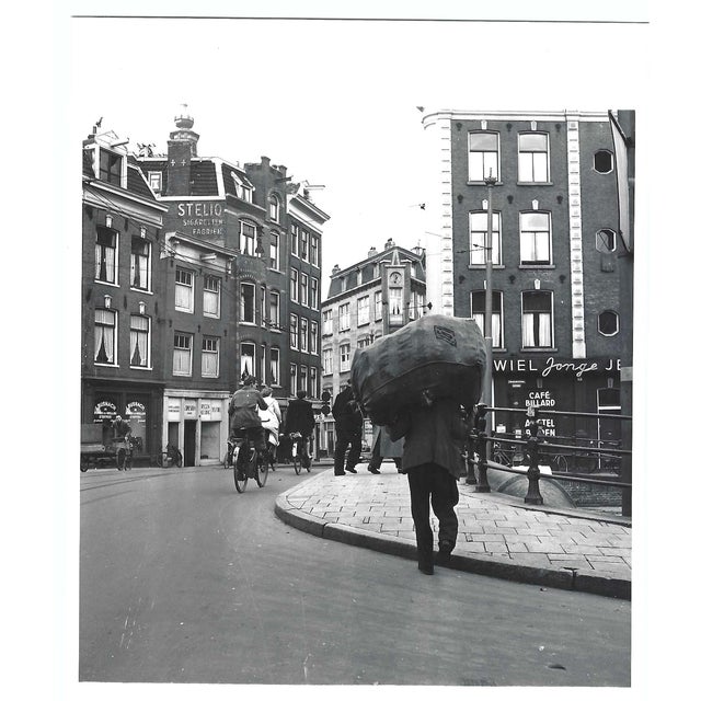 1950s black and white photograph of a street in Amsterdam, Netherlands with bikers and laborers. Blank back Combined...