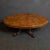 A super oval burr walnut topped coffee table from the 1860's. Reduced in height form a small dining table and a repurposed...
