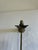 This brass candle snuffer features a whimsical winged angel figure cast at the base, complete with a hooded robe and...