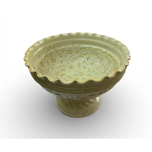 Elevate your tabletop with this striking 11-inch tall pedestal compote bowl. Featuring a soft, pale celadon green glaze...