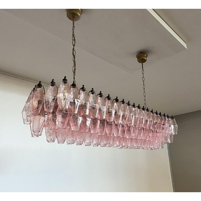 Elegant italian chandelier made from 138 beautiful murano pink glasses "poliedri". Structure in gold and brass colored...